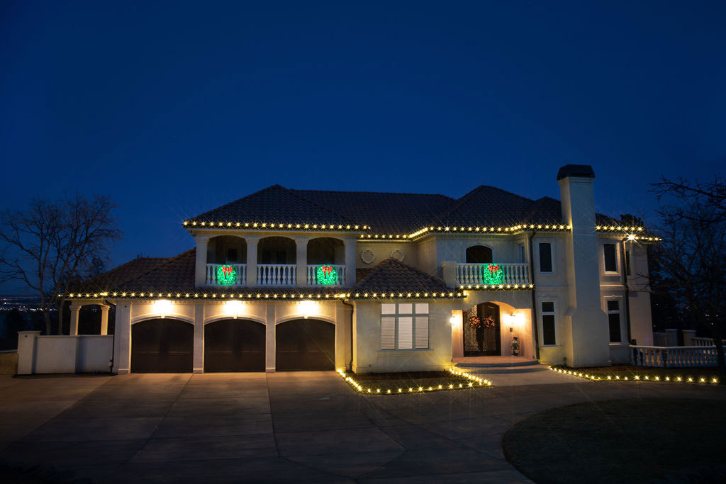 House-Brightened-By-Yellow-Lights-And-Holly-Wreaths