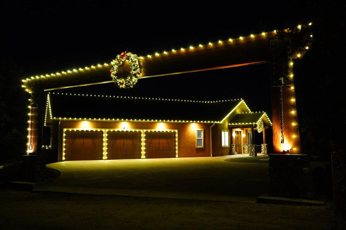 Gate-Framing-House-With-Christmas-Lighting